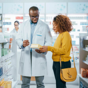 Pharmacist helping customer at a pharmacy.