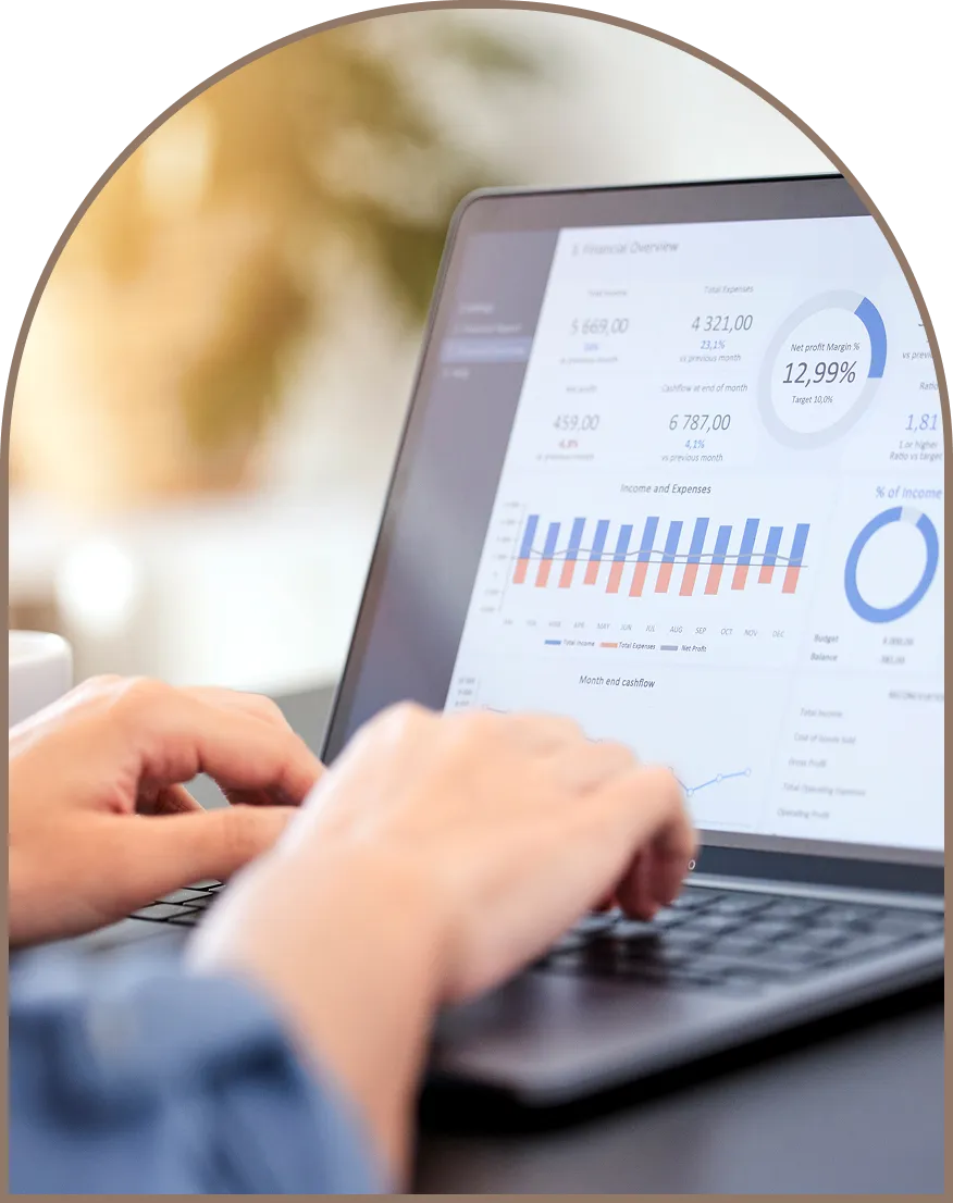 image of someone typing on their laptop with analytics on the screen